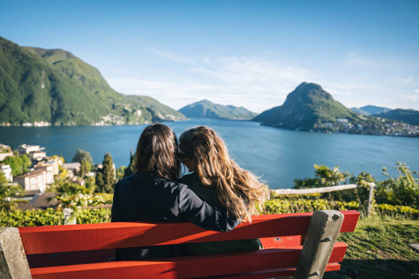 istock Young women relax at lakefront viewpoint 1321931627