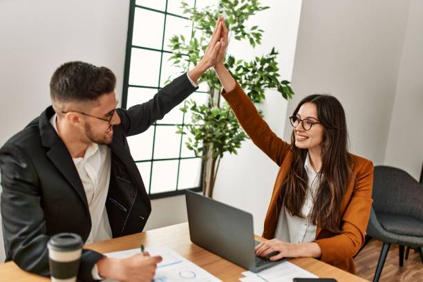 istock Two business executives raised up hands hitting five at the office. 1321931666