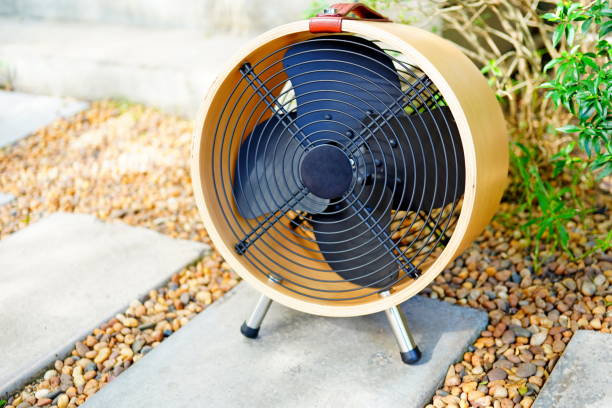 Small fan working outdoors in garden
