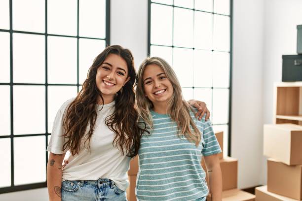 istock Young couple smiling happy and hugging at new home. 1321932342