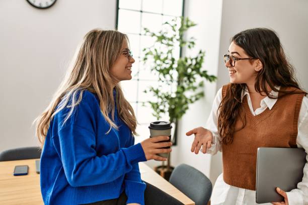 istock Two business workers woman relaxed drinking coffee and speaking at the office. 1321933062