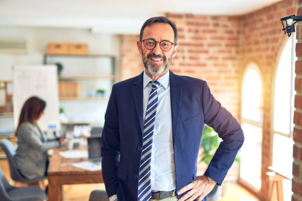 istock Middle age businessman smiling happy and confident. Standing with smile on face working with businesswoman partner at the office 1321934943