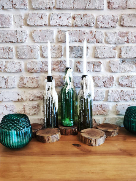 istock White decoration candles in vintage bottles on table 1321935339