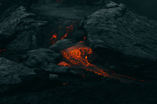 Scenic view of the dark black volcanic landscape with melting lava and volcanic eruption at Fagradalsfjall area in Iceland