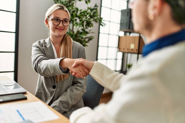 istock Two business executives shaking hands at the office. 1321936990