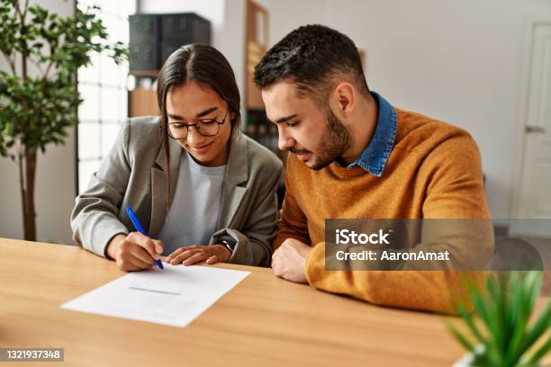 Couple Smiling Happy Signing Contract At The Office Stock Photo - Download Image Now