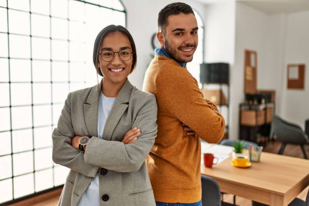 istock Two business workers smiling happy standing with arms crossed gesture at the office. 1321937355