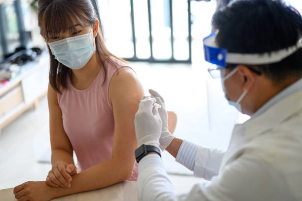 istock The doctor prepares the syringe for vaccination 1321940074