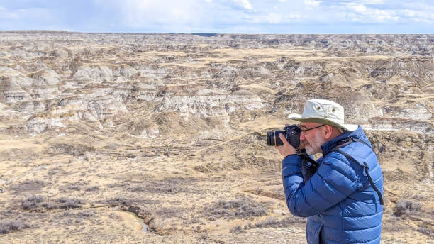 Man taking pictures of Badlands
