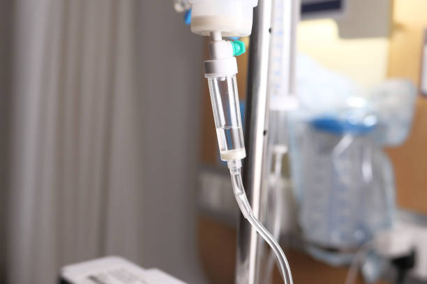 istock saline solution dripping at hospital room , close up 1321941675