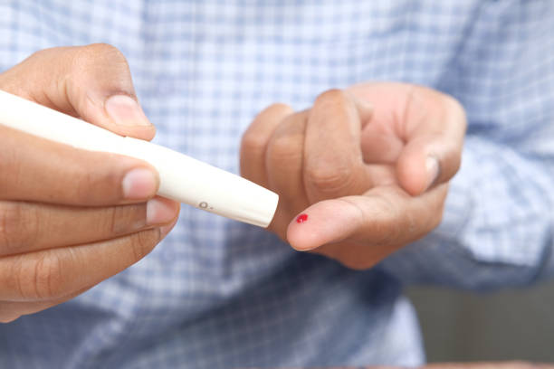istock man's hand measuring blood sugar level 1321942098