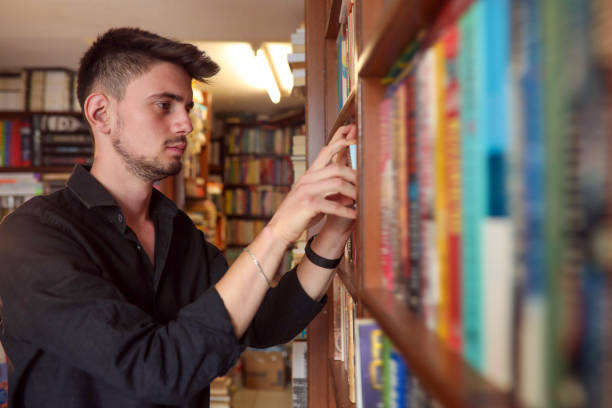 istock young man Looking For Books And information in The Library 1321942289