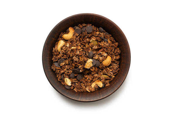 istock Chocolate granola cereal with nuts in a bowl background. 1321949831