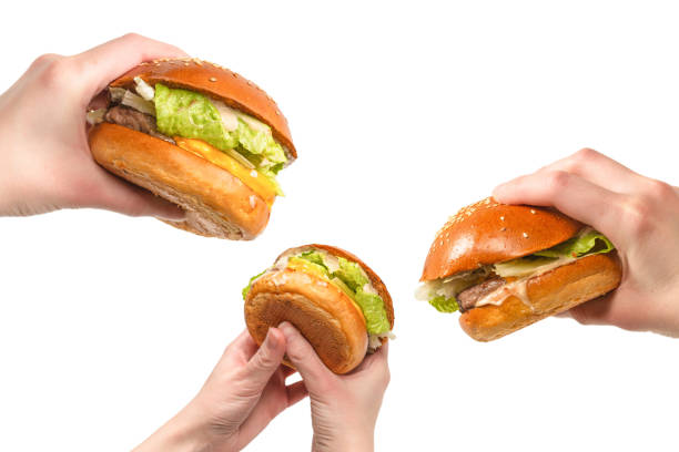 istock Hamburger in woman hands isolated on a white background. 1321949916