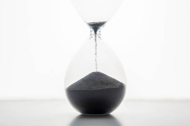 istock Hourglass on a light background. Time is money. Business solutions in time. 1321955198