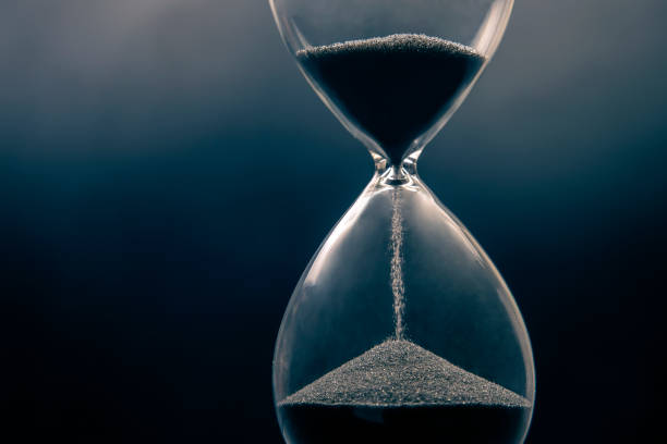 istock Hourglass on a dark background. Time is money. Business solutions in time. 1321955340