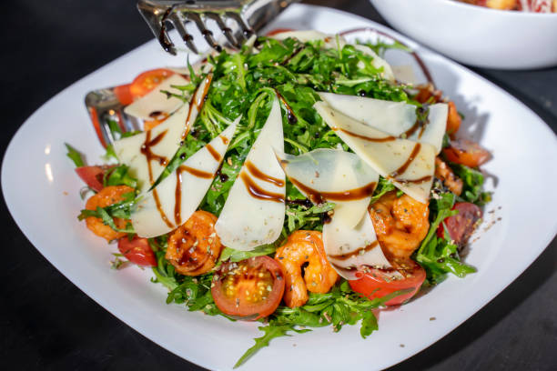 istock appetizing delicious Caesar salad with shrimps 1321956787