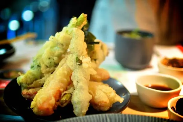 A Tempting crispy and hot plate of vegetables tempuras with dipping sauce
