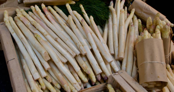 istock White asparagus spears displayed for sale in crates 1321960625