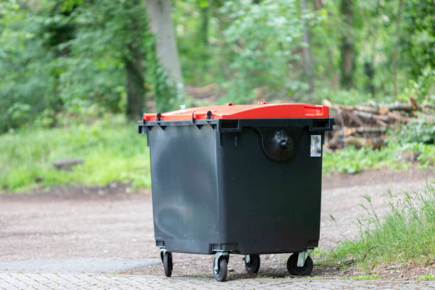 istock black garbage tin with red lid, forest in the background 1321961505