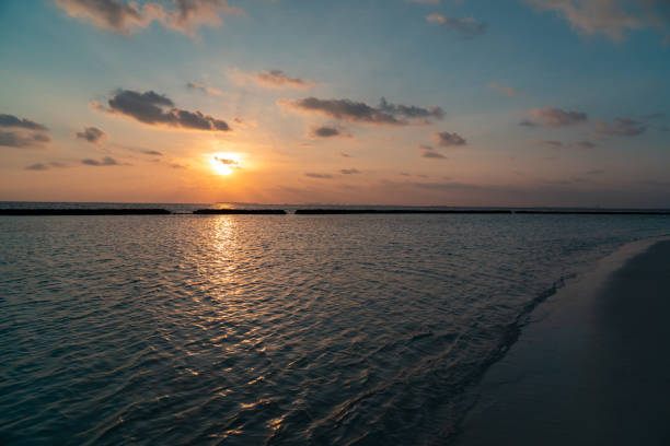 istock Panoramic landscape of Maldives tropical beach during sunset. 1321963615
