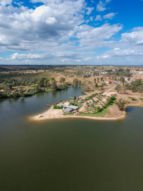 istock Aerial view from a lake with a beach at the sunset 1321964432
