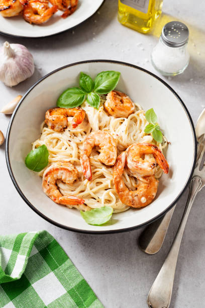 istock Pasta spaghetti with grilled shrimp and creamy alfredo sauce 1321965083