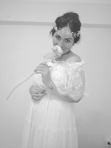 beautiful bride girl with plain white veil front of white background. studio shot. fashion shot. raw photo.