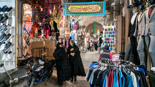 Iranian people shopping in Grand bazaar of Isfahan, Iran Isfahan, Iran - May 2019: iranian ancient isfahan grand bazaar, market full of carpet or souvenir shops. A popular landmark in Isfahan with tourists and local people shopping. tehran stock pictures, royalty-free photos & images