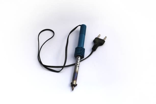 istock Burnt cheap electric soldering iron with blue handle isolated on white background 1321975951