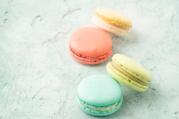 istock colorful macaroons on green background with copy space 1321979335