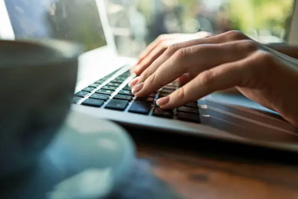 Photo of Hands of a unrecognizable man typing on a laptop
