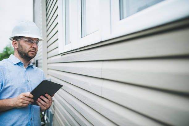 istock Building inspector checking the windows of a residential building 1321985189