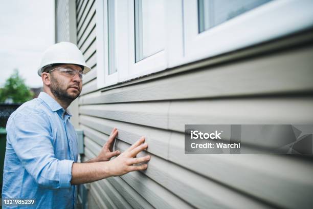 Building Inspector Checking The Windows Of A Residential Building Stock Photo - Download Image Now