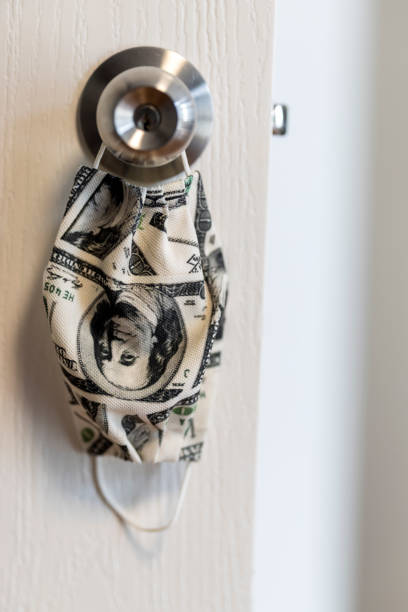 istock Protection face mask door handle quarantine concept with US dollar pattern 1321988079