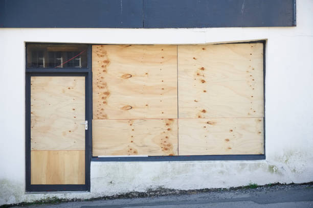 istock Shop front with blank sign and closed shutter door 1321989680
