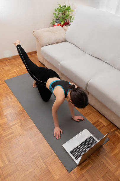istock young woman exercising at home 1321996547