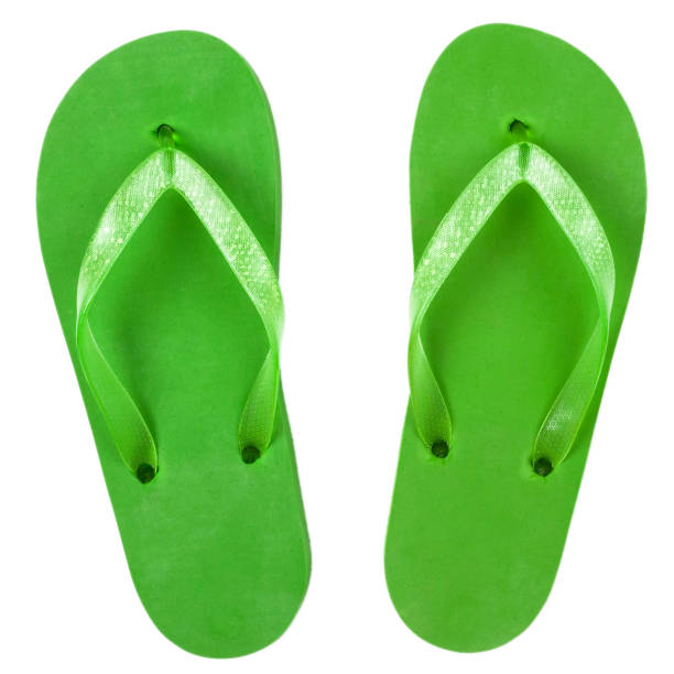 green rubber beach flip flops on a white background, isolate, view from above green rubber beach flip flops on a white background, isolate, view from above. flip flop sandal beach isolated stock pictures, royalty-free photos & images
