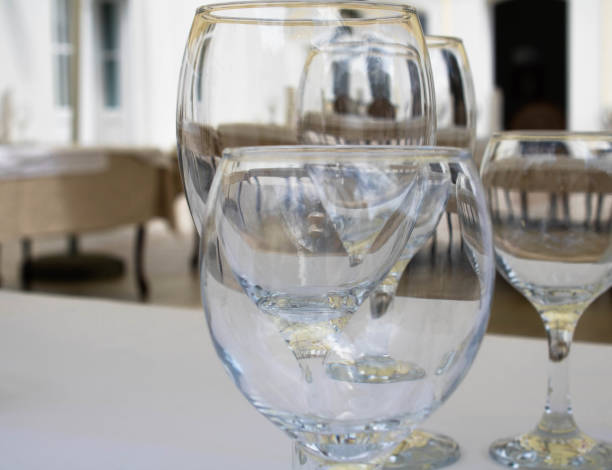 istock Emtpy transparent wine glasses on a table in a restaurant outdoors, close up 1322004491
