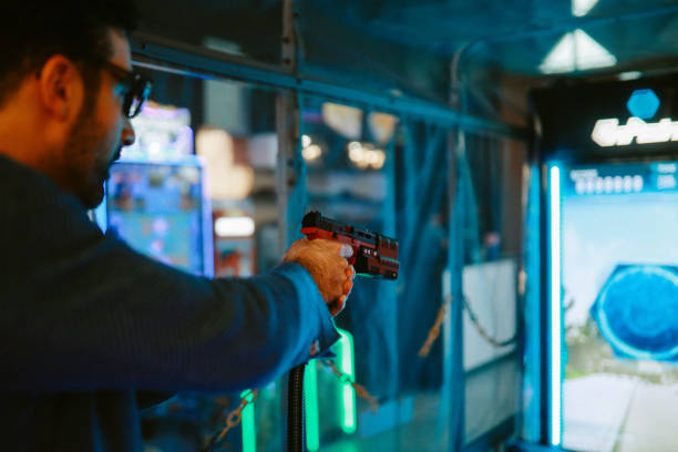 istock man playing a shooter game in the arcade 1322009494