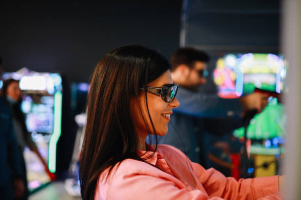 istock woman playing a shooter game in the arcade 1322009615