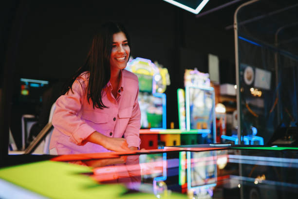 Young couple having fun in the video games arcade, spending a fun weekend together.