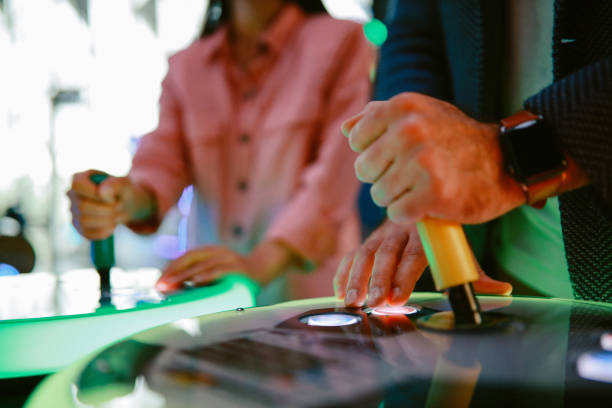 istock young couple in the video game arcade, close up on the hands 1322010991