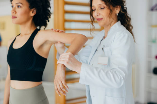 istock Physiotherapist Helping Beautiful African American Woman with Hand Exercise 1322012178