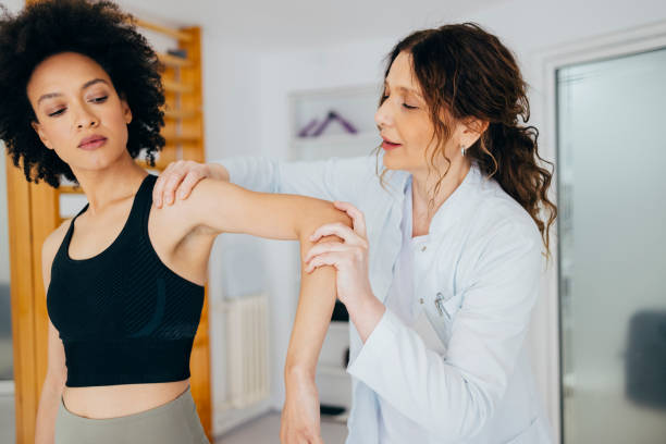istock Physiotherapist Helping Beautiful African American Woman with Hand Exercise 1322012190