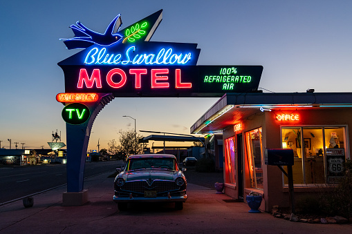 Tucamcari, New Mexico - May 6, 2021: Close up of the Blue Swallow Motel neon sign, a famous classic Route 66 motel