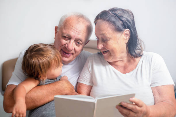 istock Senior read the book to baby 1322019279