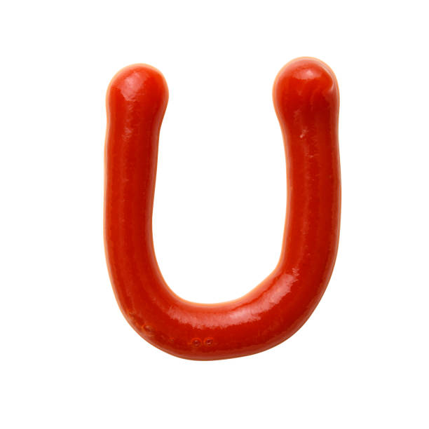 Isolated shot of uppercase alphabet U written in ketchup on white background Uppercase alphabet U written in ketchup, isolated on white with clipping path. healthy eating red above studio shot stock pictures, royalty-free photos & images