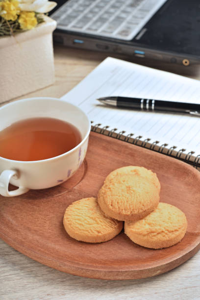 istock Coconut cookies with tea on the wooden tray 1322038468
