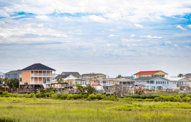 Coastal vacation houses next to marsh stock photo
